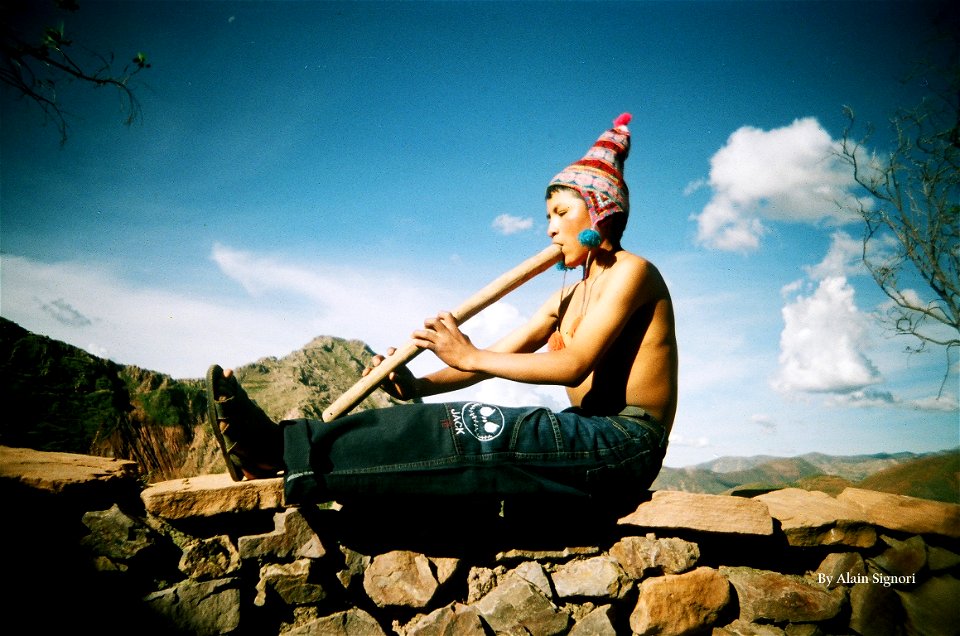 Bolivian boy playing flute