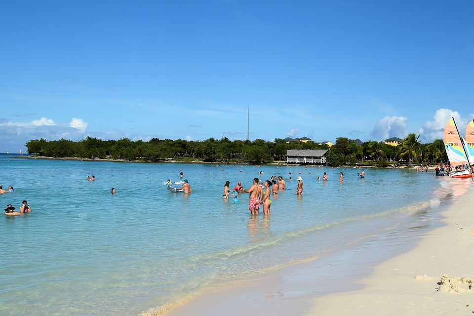 Colorful kayaks and sailing boats on a tropical beach in Cuba