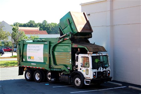 Ex ESI truck 214151 picking up a dumpster