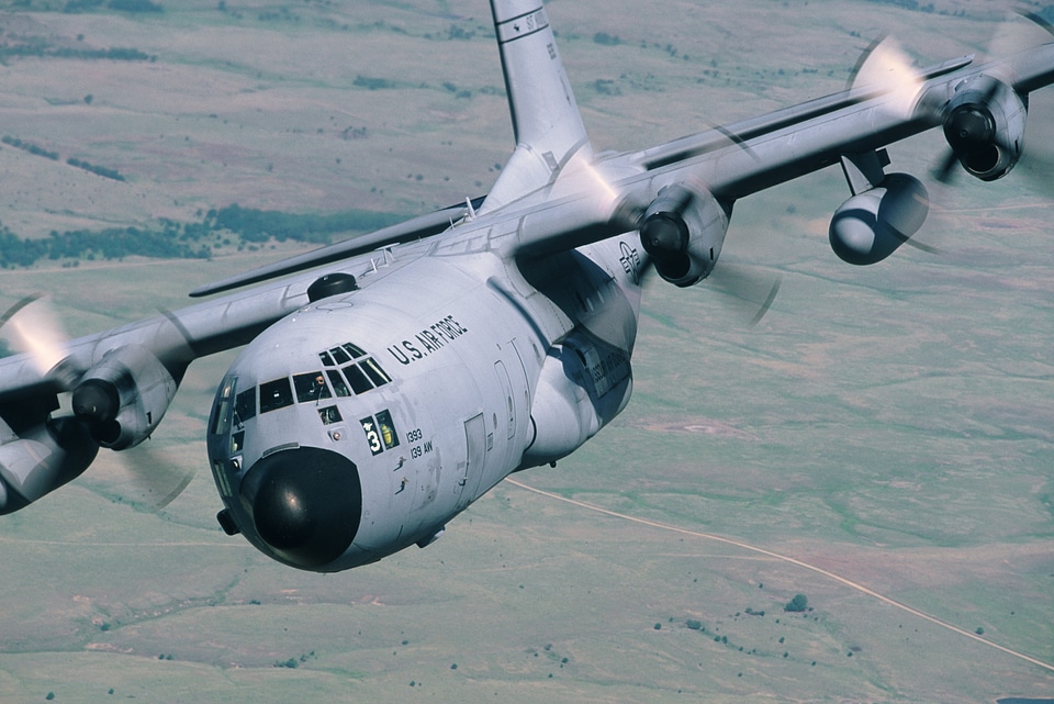 C-130 close up flying clear sky