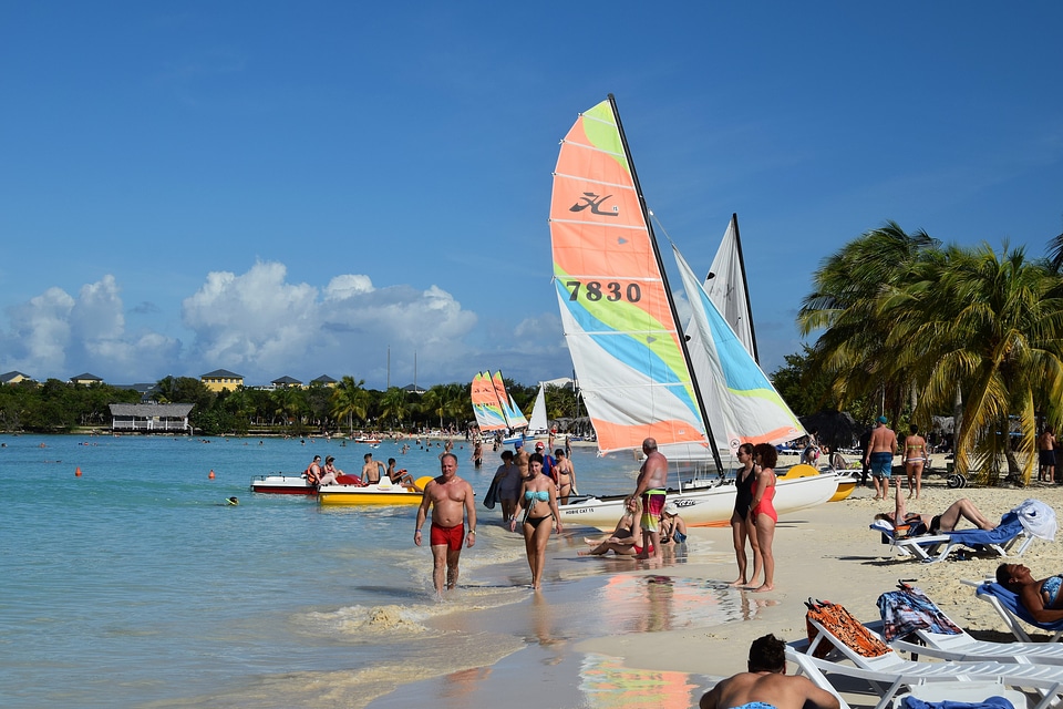 Colorful kayaks and sailing boats on a tropical beach in Cuba