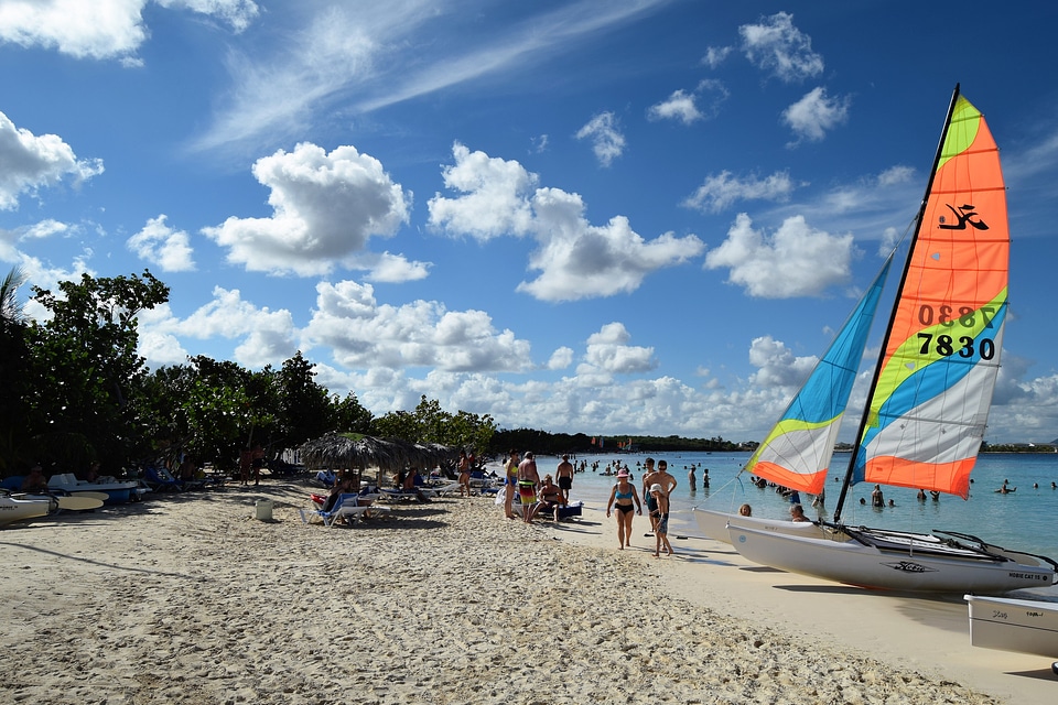Colorful kayaks and sailing boats on a tropical beach in Cuba