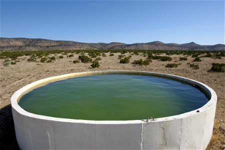 Mountains fill the horizon over this water storage facility in West Texas.