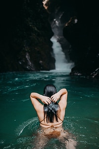 A girl swims in a natural pool photo