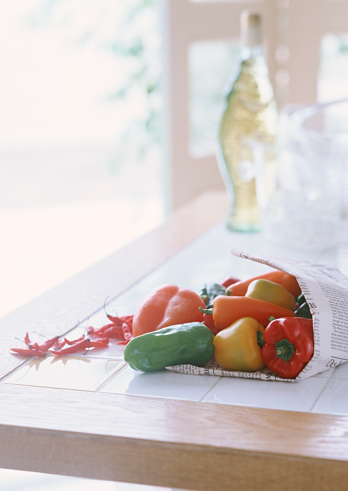 Colored peppers on wooden table