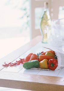 Colored peppers on wooden table photo