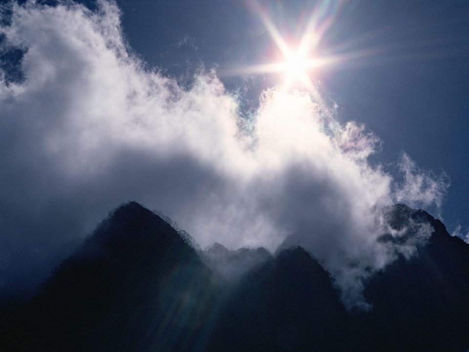 Sunny landscape in mountains and the dark blue sky