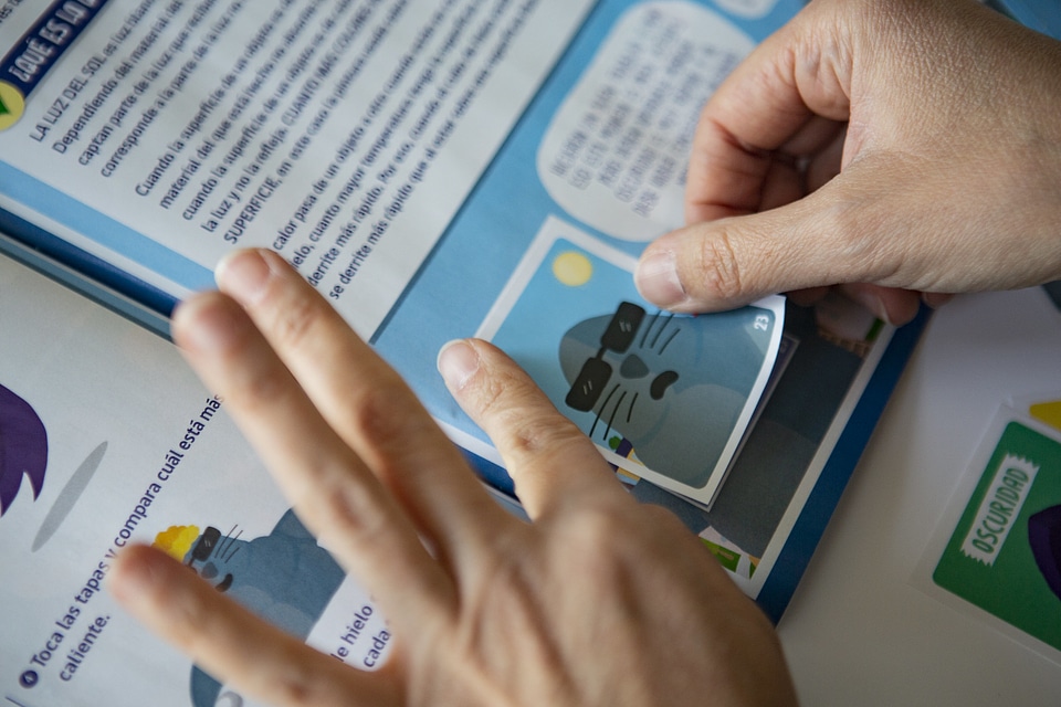 A man pasting stickers into the collection album