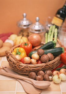 Different fresh vegetables in basket on the table photo