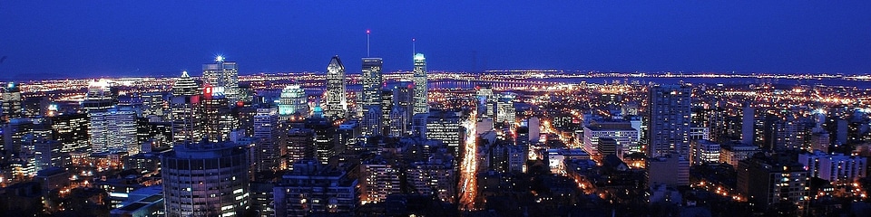 Montreal over river at sunset with city lights and urban building photo