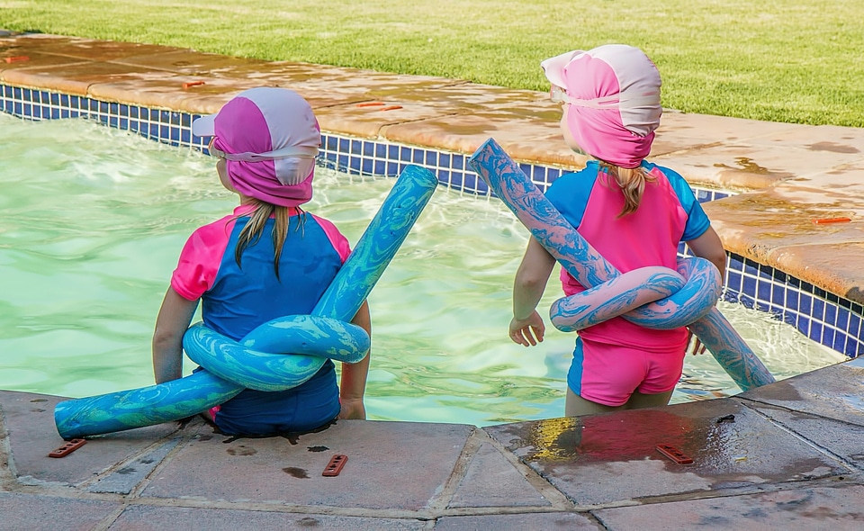 Photo of two cute girl in swimming pool photo