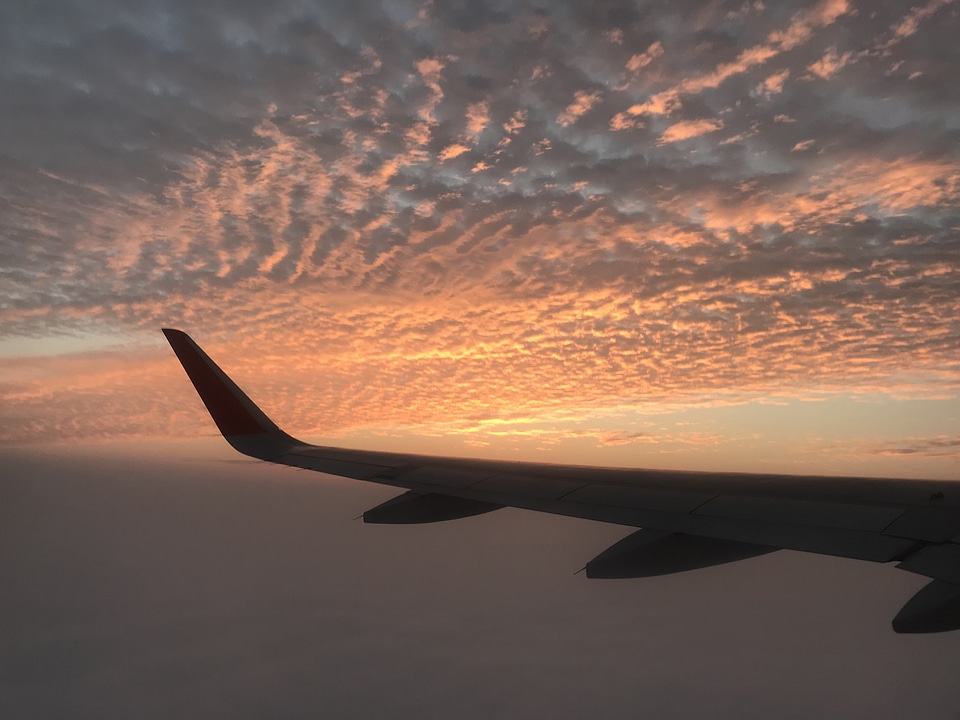 Wing of an airplane in the sunset