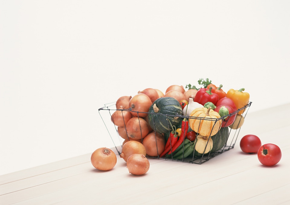 Wire shopping basket in vegetable on table