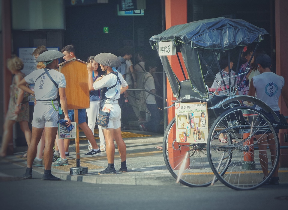 A rickshaw workers carry a passenger