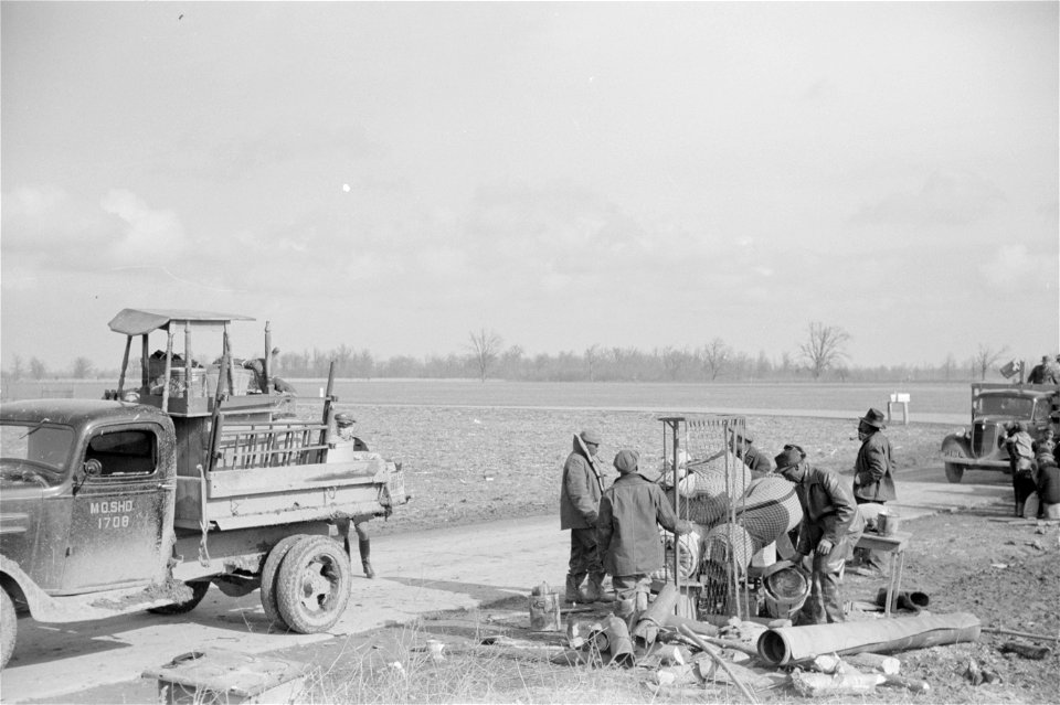 State highway officials moving sharecroppers away from roadside to area between the levee and the Mississippi River, New Madrid County, Missouri. Historic photo.