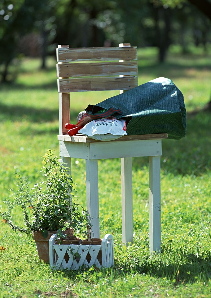 beautiful garden with flower pots and chairs