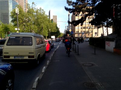 Cycling past cars photo