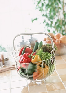 Assortment of fresh fruits and vegetables in metal basket