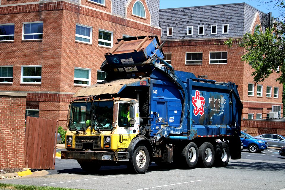 Ex AAA truck picking up an AAA dumpster