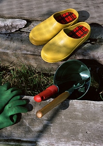 Gardening tools on grass on wooden background photo