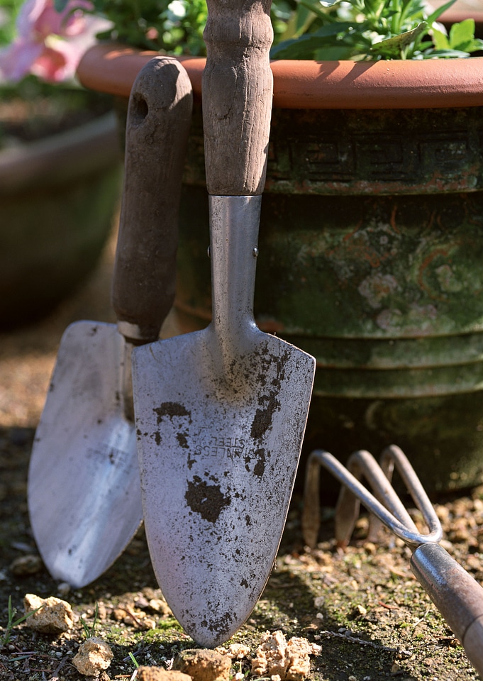 tools for working in the garden on the porch of a house