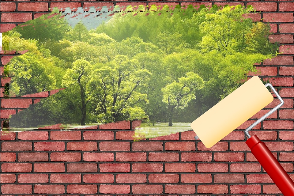 Paint brush and wall with natural landscape