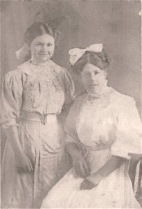 Two ladies, one seated photo