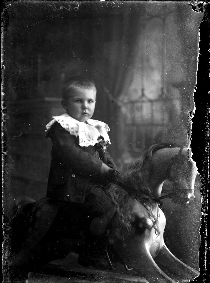 Child from the Moss family on rocking horse, [n.d.]