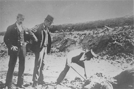 One man digging, two watching on, [n.d.] photo