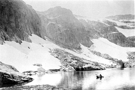 Person in a canoe amidst snow covered mountains, [n.d.] photo