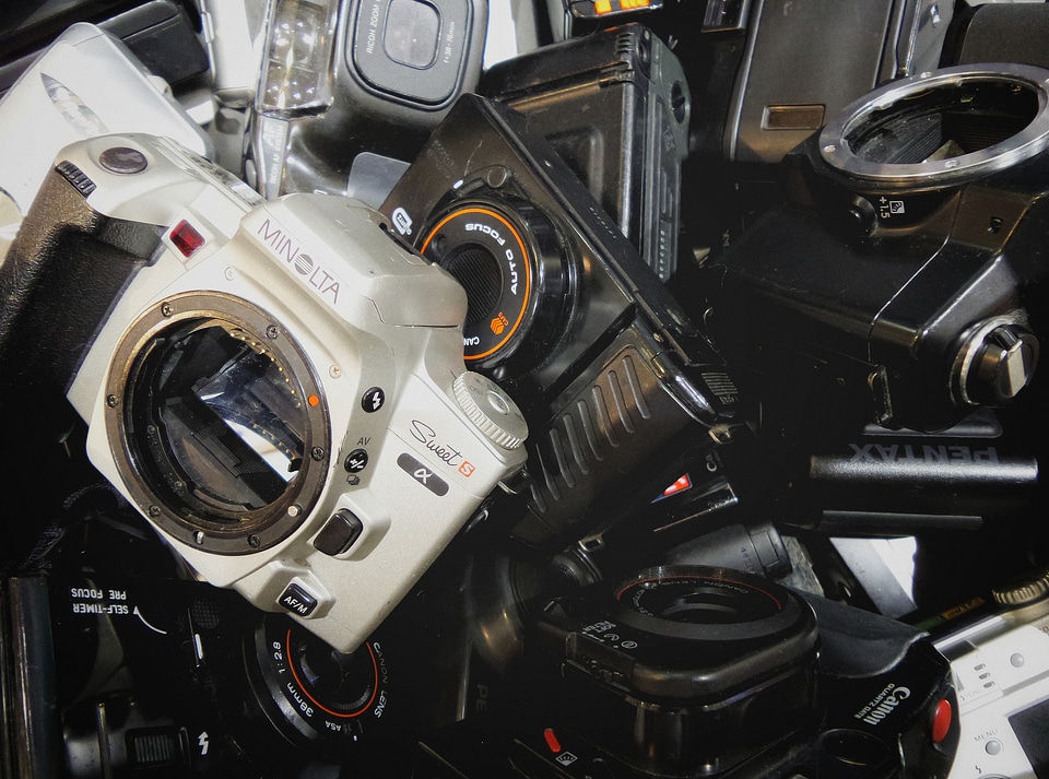 An assortment of used, dusty, disposable cameras