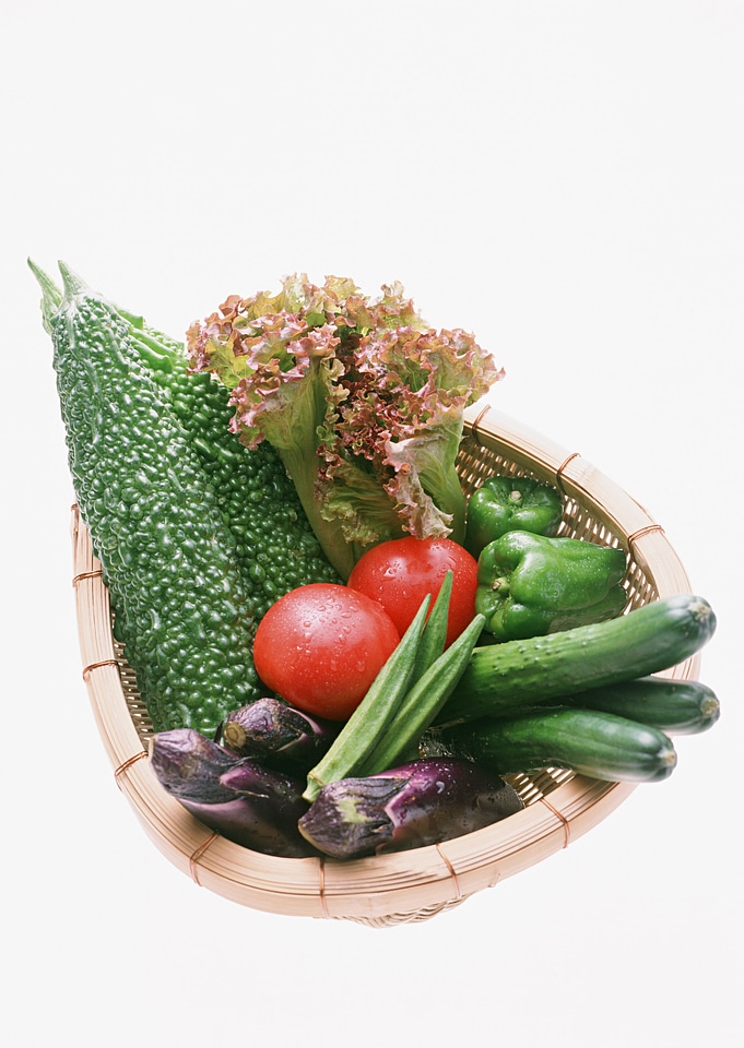 Composition with raw vegetables and wicker basket
