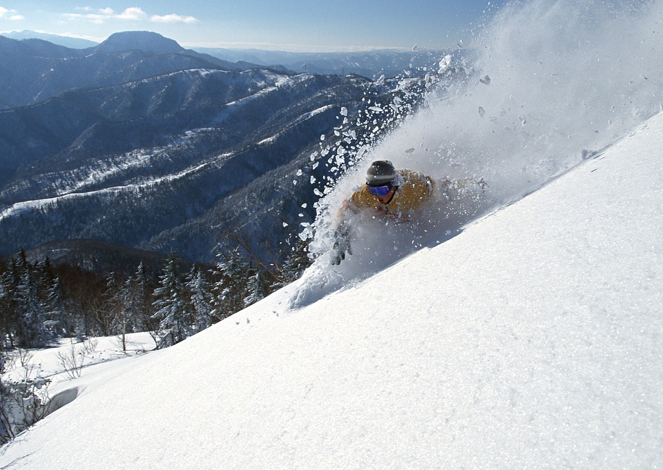 skier in deep powder on a steep slope