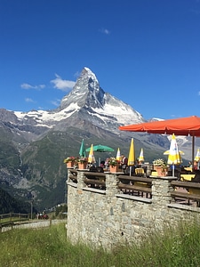Tourist taking view of Matterhorn in autumn at outside restaurant photo