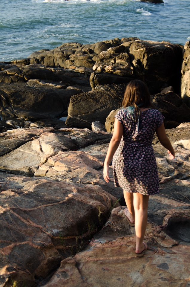 A young woman walks alone on a beach photo