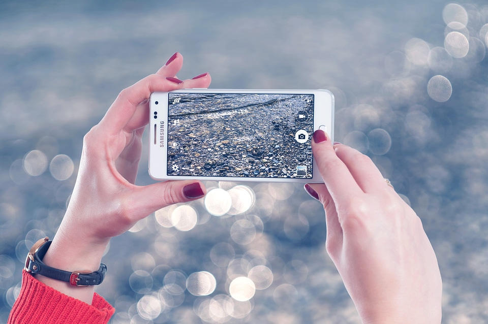 Beautiful young hipster woman using smart phone