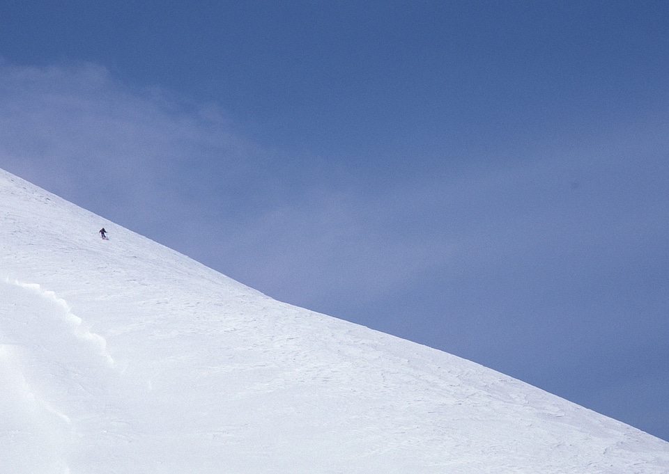 Skier coming down the slope fast