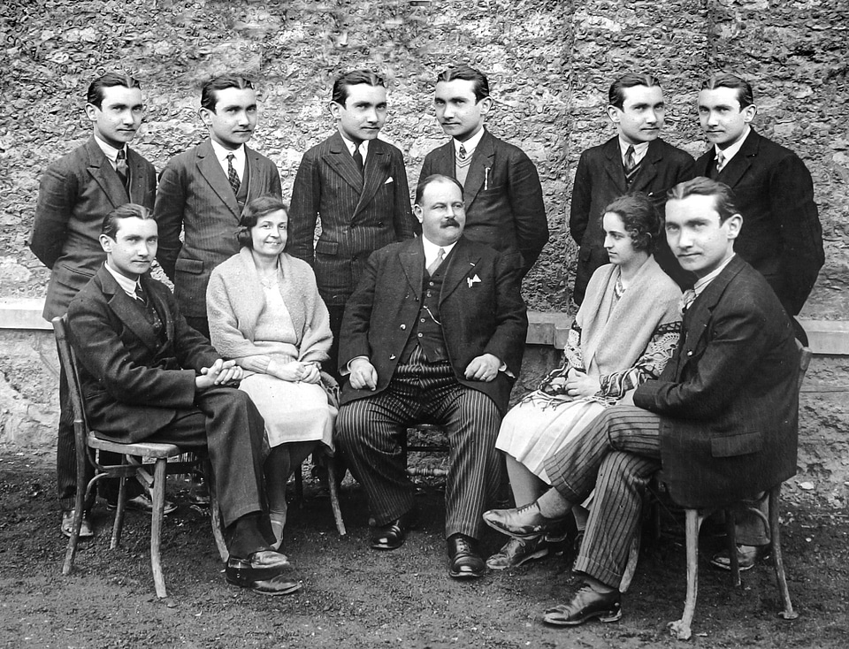 An antique Black & White photo show a group of business