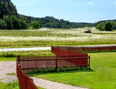 Red fence and fields on Röe gård 2 photo