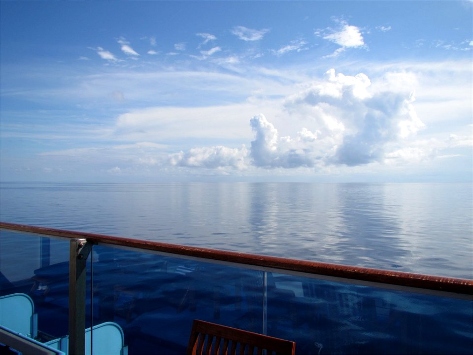 Clouds reflect on calm waters