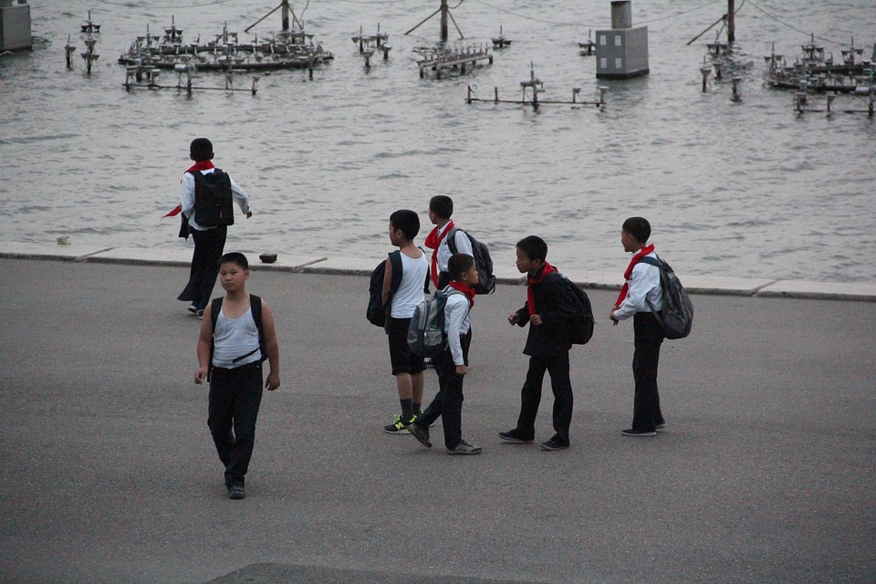 Young pioneers walk through the bright streets