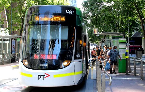 Passenger in wheelchair boarding an E class tram in Bourke Street