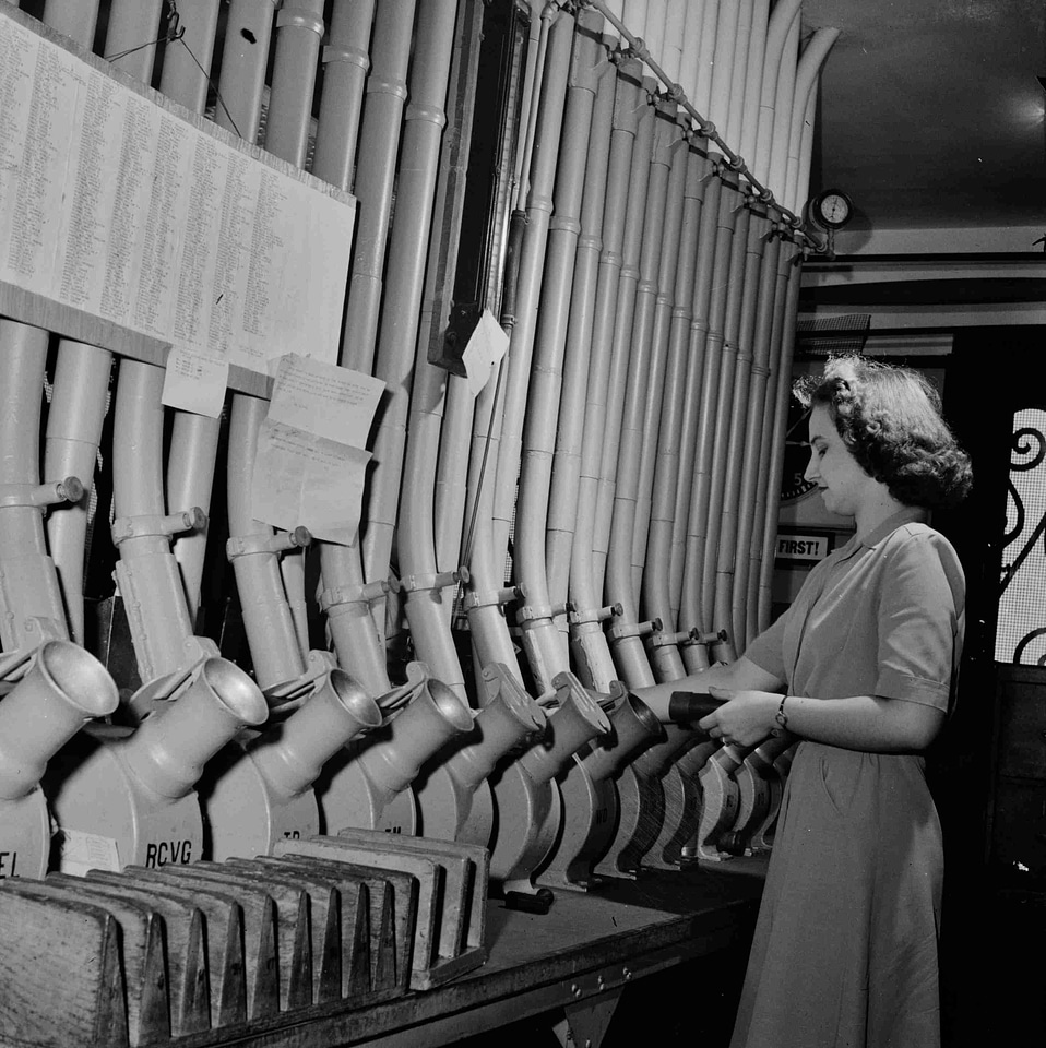 Woman works with the pneumatic tubes