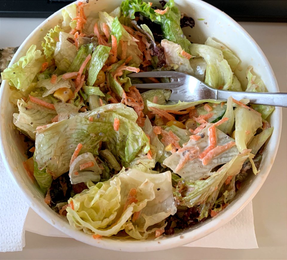 fresh greens with cucumbers, corn, carrots and César dressing