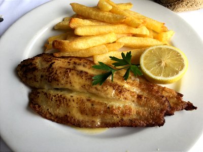 Fresh cooked Prowfish with french fries, lemon and a butter souse. Served in a well known fish restaurant in Sandton, South Africa photo