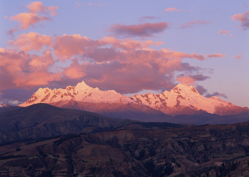 lighted mountain peaks with snow at winter