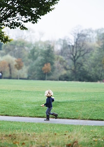boy running across hill photo