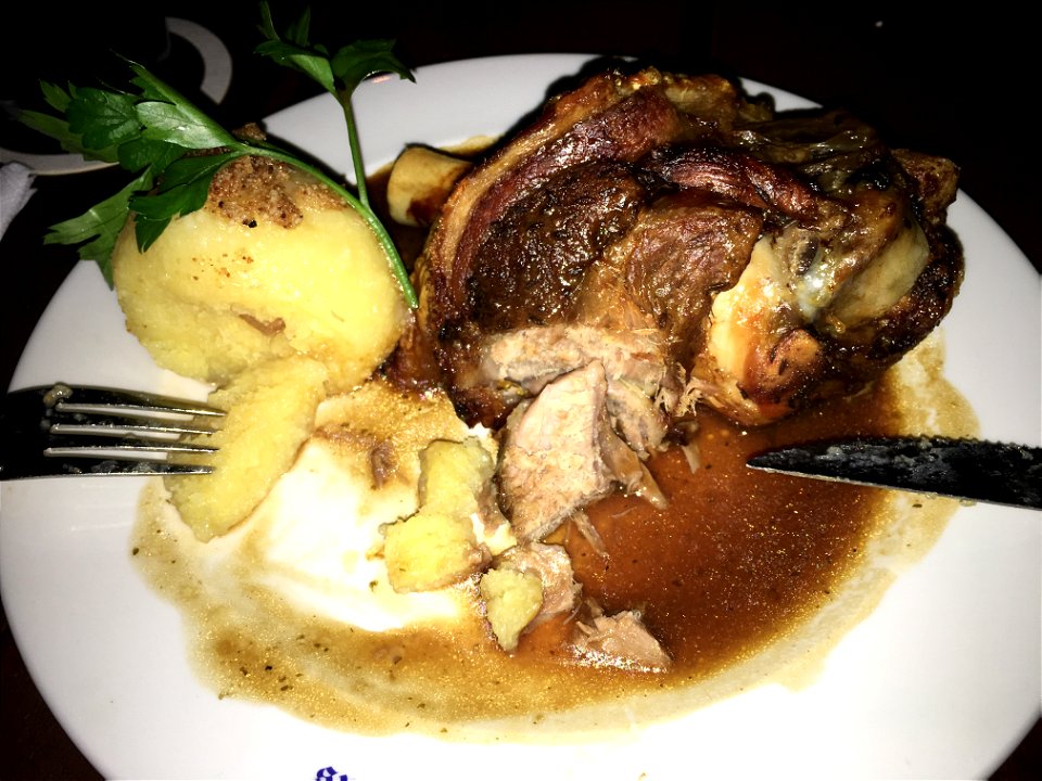 Bavarian knuckle with dumpling in a traditional restaurant in Munich.