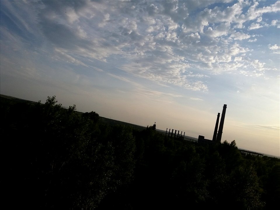 Abandoned factory, cloudy sky, lots of trees