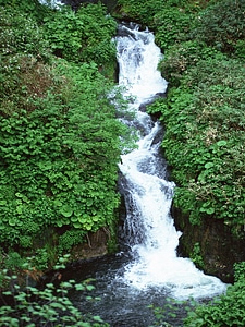 Waterfall in a mountain gorge photo